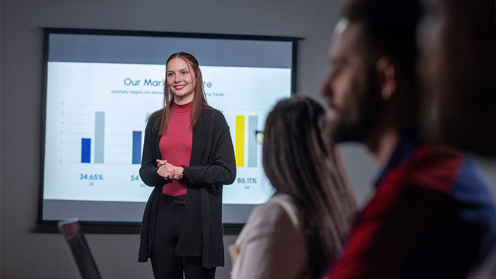 PennWest graduate giving a business presentation.